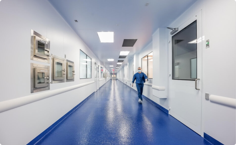 Worker walking in the hallways of Lykan Bioscience facility.