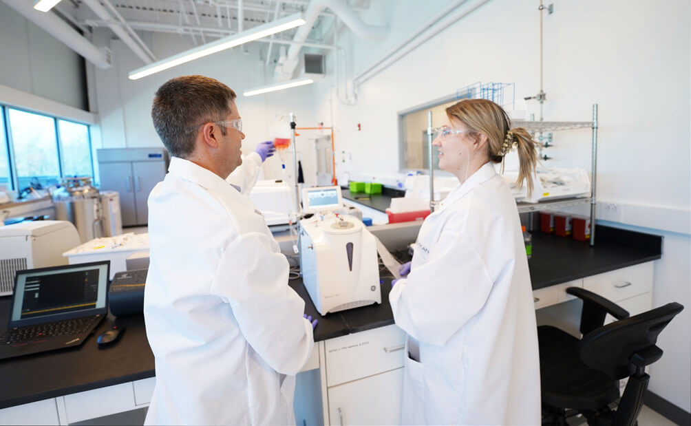 Two Lykan employees having a conversation while analyzing materials