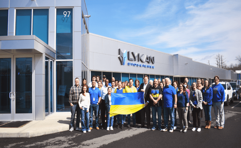 Lykan Bioscience team holding up the Ukraine flag.