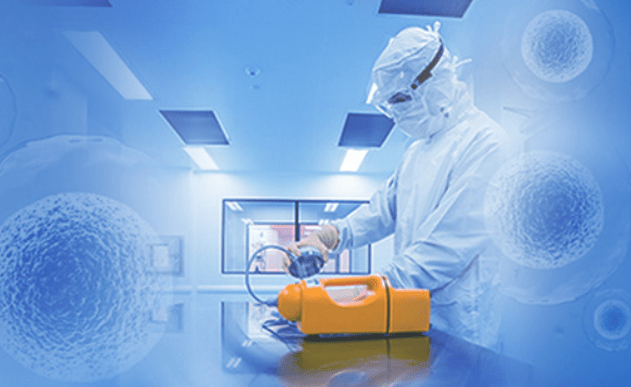 Worker in sterile suite working on cell therapy processes.
