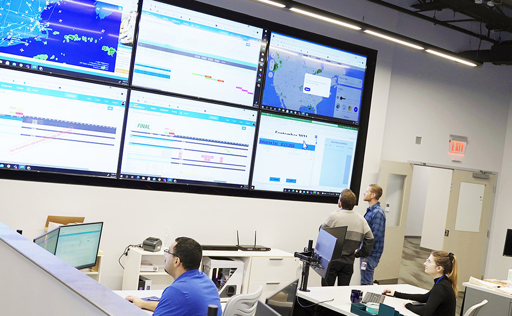 Lykan employees looking at screens at the command center
