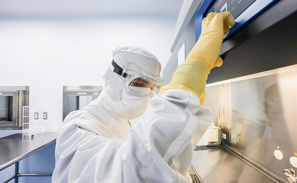 Lykan gowned worker in cleanroom