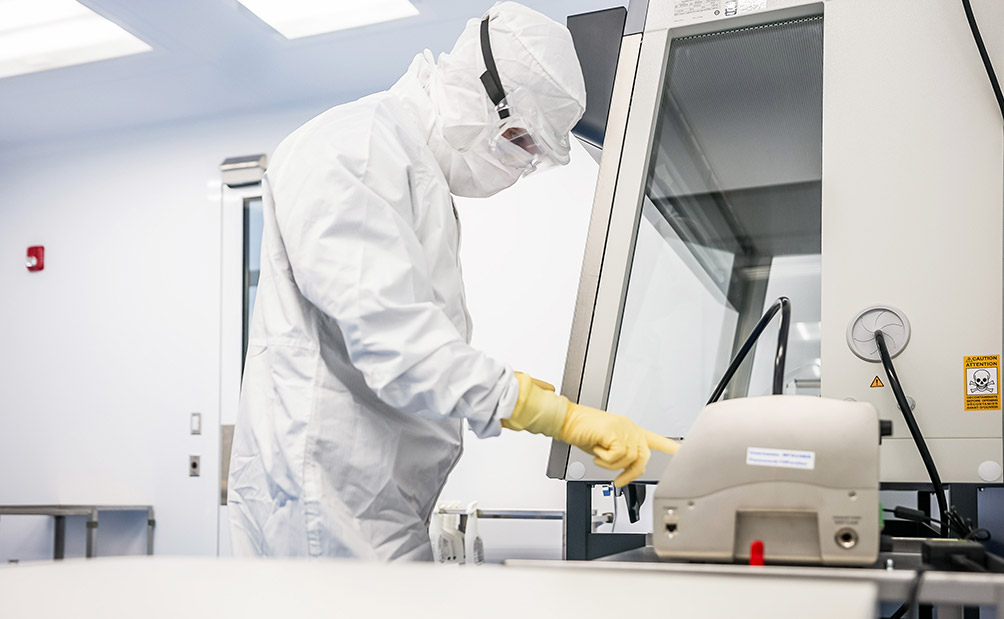 Lykan gowned worker working with bioscience products