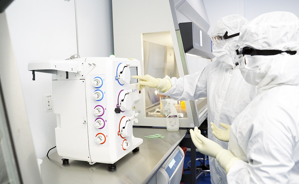 Lykan gowned workers in bioscience lab