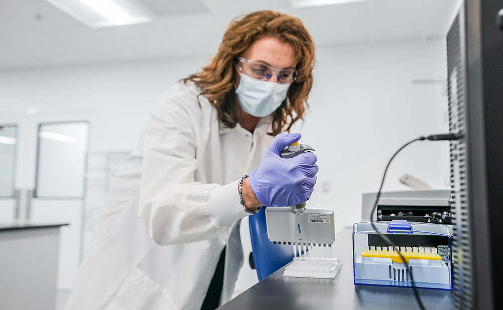 Cell therapy quality control scientist in lab.
