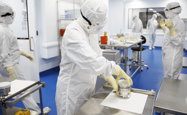 Cell therapy quality control scientists in lab.