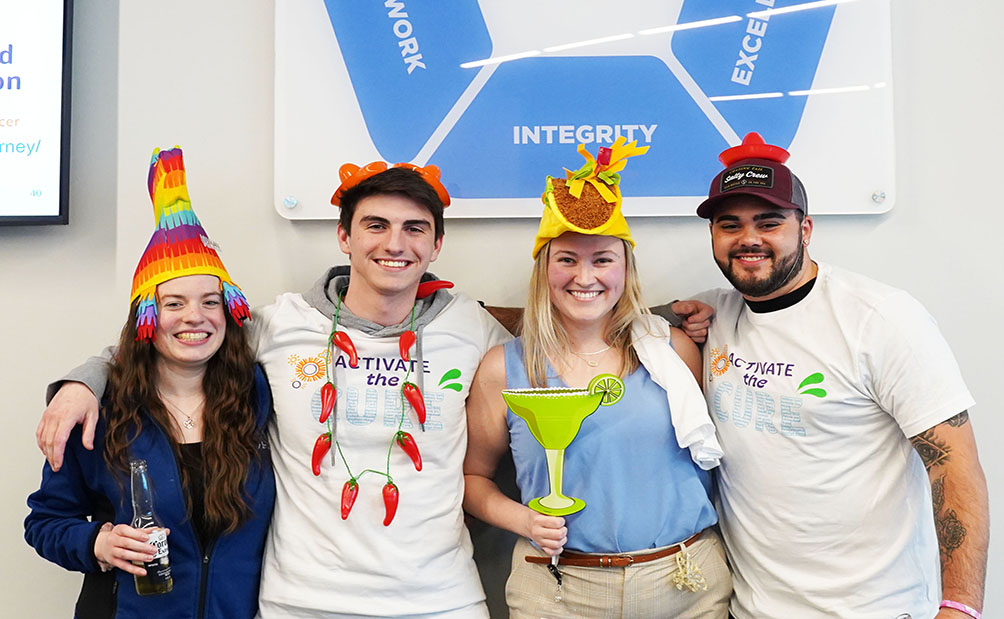 Lykan team members celebrating Cinco de Mayo with festive hats and props.