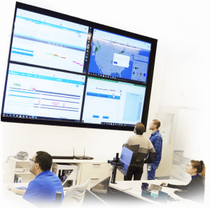Employees looking at large computer screen