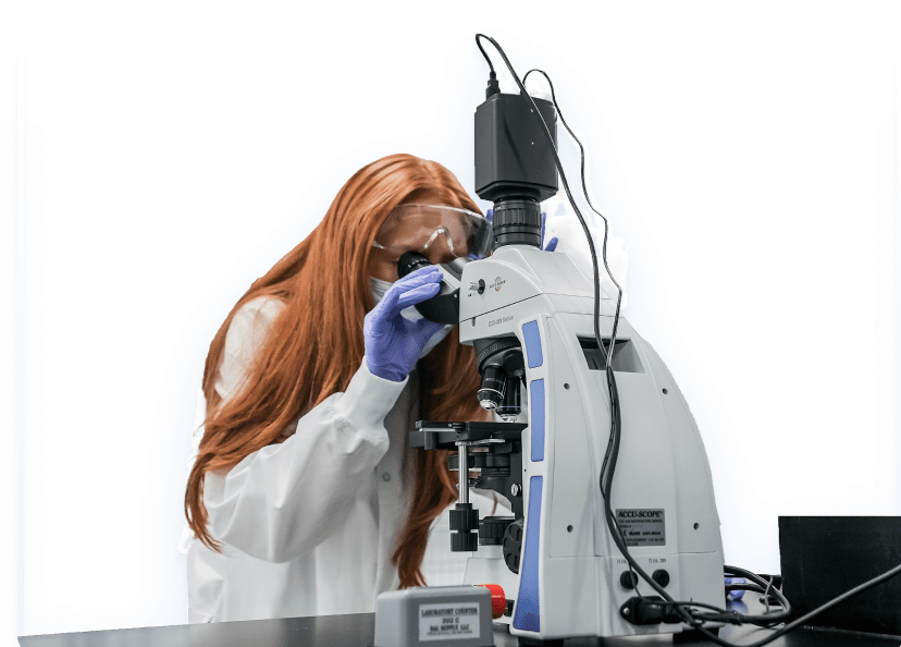 Female scientist looking at microscope